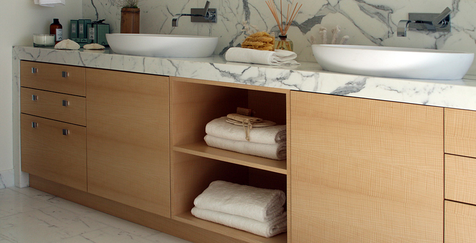 Custom English sycamore veneer bathroom cabinetry.