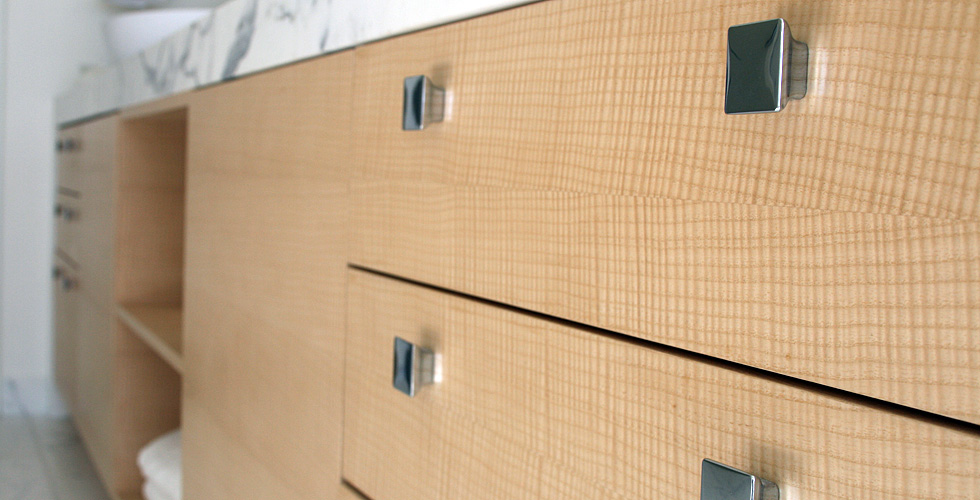 Custom English sycamore veneer bathroom cabinetry.