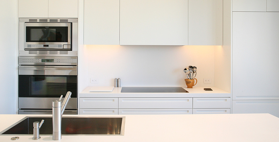 Contemporary cabinetry in the kitchen, bathroom, bedroom and office.
